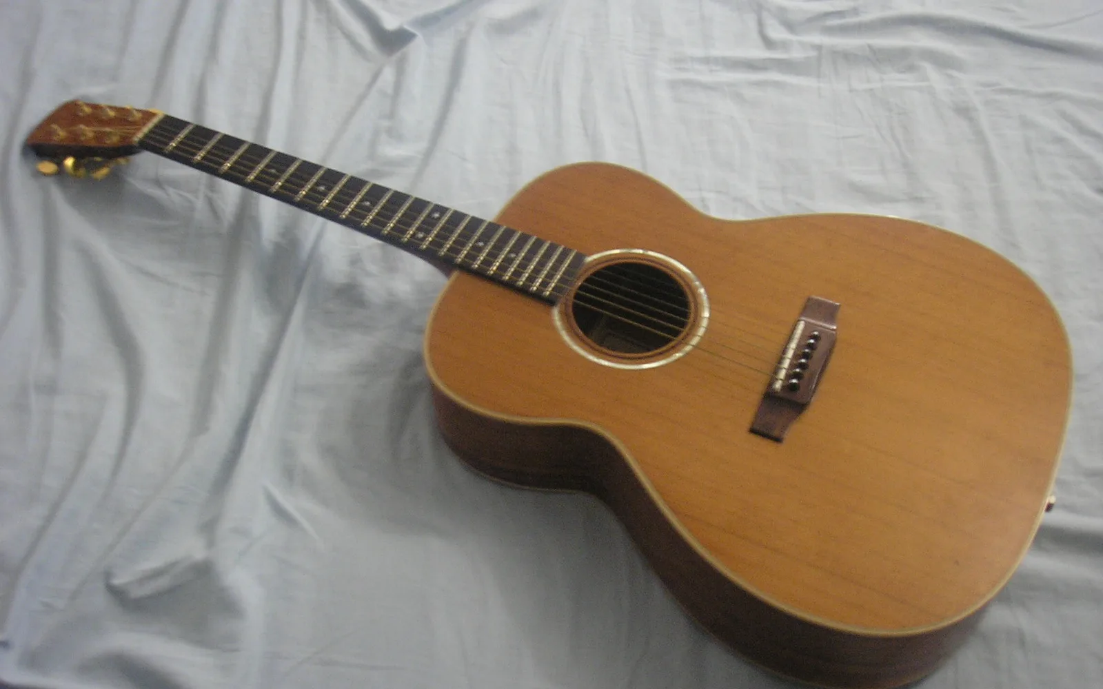 Acoustic guitar on wooden surface, illustrating the musical heritage of the Bakersfield Sound